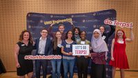 students hold signs that read, 