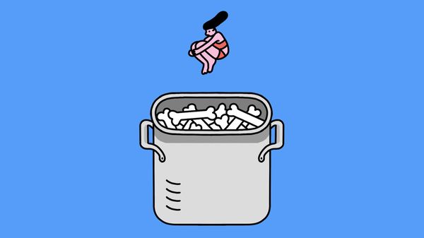 A person dive-bombing into a cooking pot full of bones